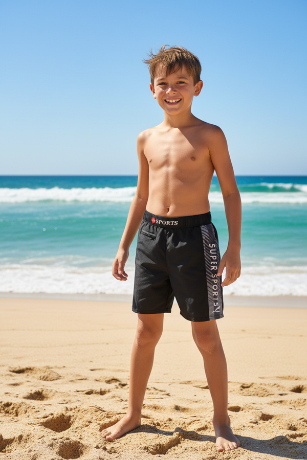 Boy on beach wearing Konexpro Super Sportsy swim shorts