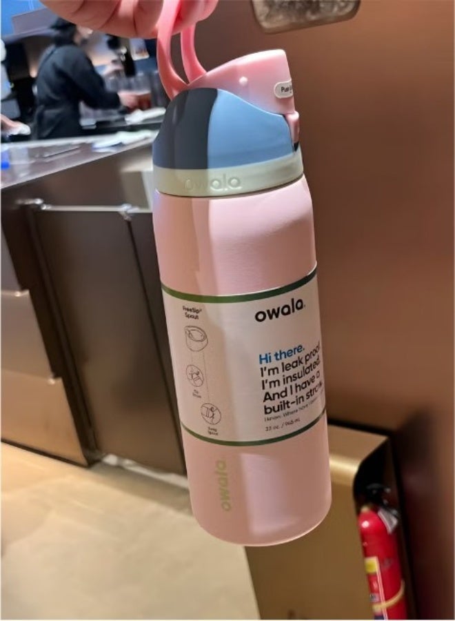Owala FreeSip 32oz pink - held at cafe lifestyle shot