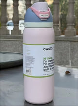 Owala FreeSip 32oz pink - outdoor lifestyle on stone surface