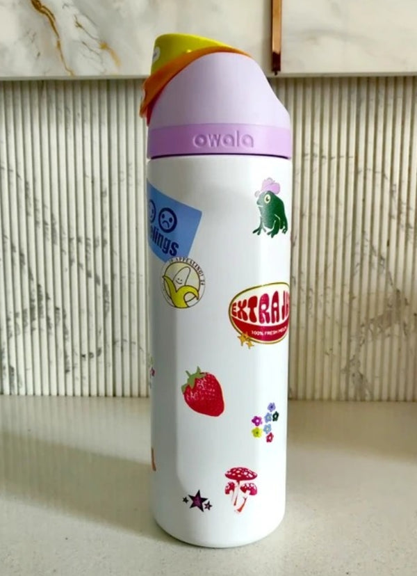 Owala FreeSip Sticker Edition water bottle - lifestyle rainy window
