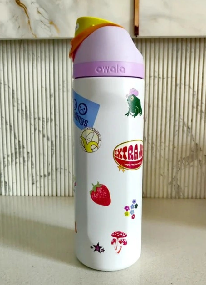 Owala FreeSip Sticker Edition water bottle - lifestyle rainy window