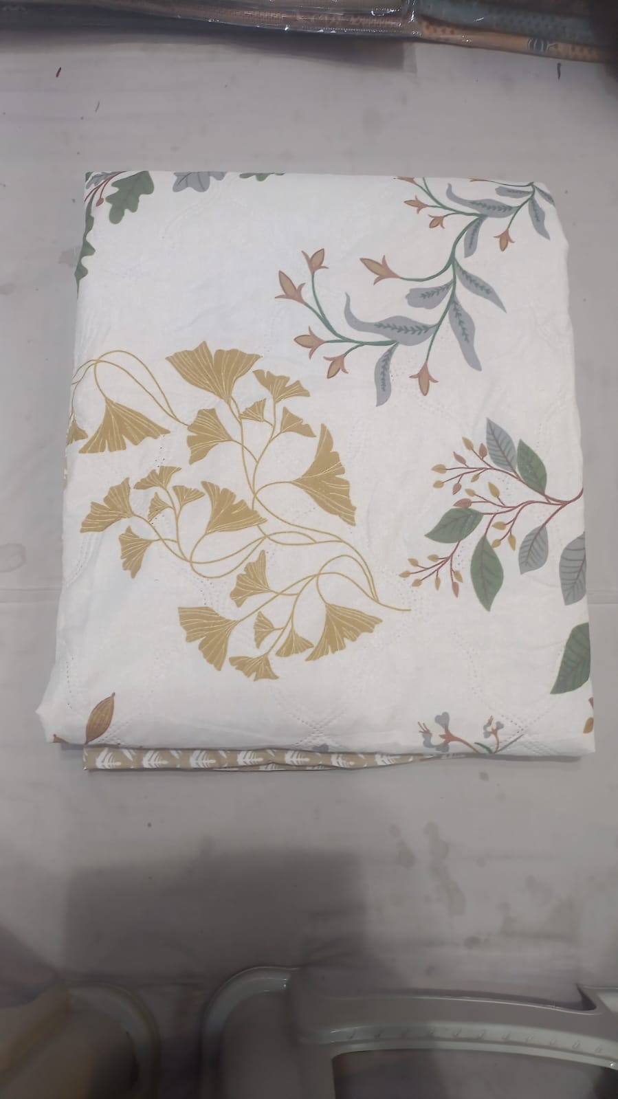 White bedsheet with golden ginkgo leaf and green botanical foliage print